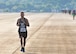A runner in the 2016 Falcon 5K runs on the flightline at Dobbins Air Reserve Base, Ga. September 11, 2016. (U.S. Air Force photo/Master Sgt. James Branch)