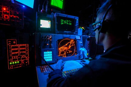 IMAGE: U.S. 5TH FLEET AREA OF RESPONSIBILITY – Operations Specialist 2nd Class Alex Moore monitors radars to identify aircraft in the Combat Information Center aboard the multipurpose amphibious assault ship USS Bataan (LHD 5). The Navy is refocusing efforts to develop and deploy new technologies impacting electromagnetic maneuver warfare, including radar, for integration in the Fleet and its carrier strike groups, the Naval Surface Warfare Center Dahlgren Division announced, Nov. 1, 2017.