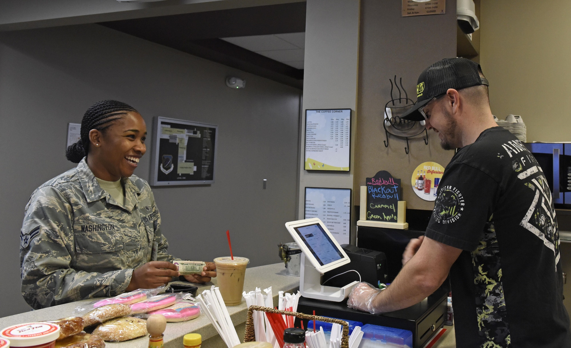 Larry Bowman, U.S. Air Force retiree and owner of the Coffee Corner, cashes out a customer at Fairchild Air Force Base, Wash., Sept. 26, 2017. Bowman enlisted July 2001, and was stationed at Fairchild for 14 years, during which he was a flight chief for a section of crew chiefs and deployed overseas seven times. He retired June 2015, and stayed in the local area. (U.S. Air Force photo/Airman 1st Class Jesenia Landaverde)