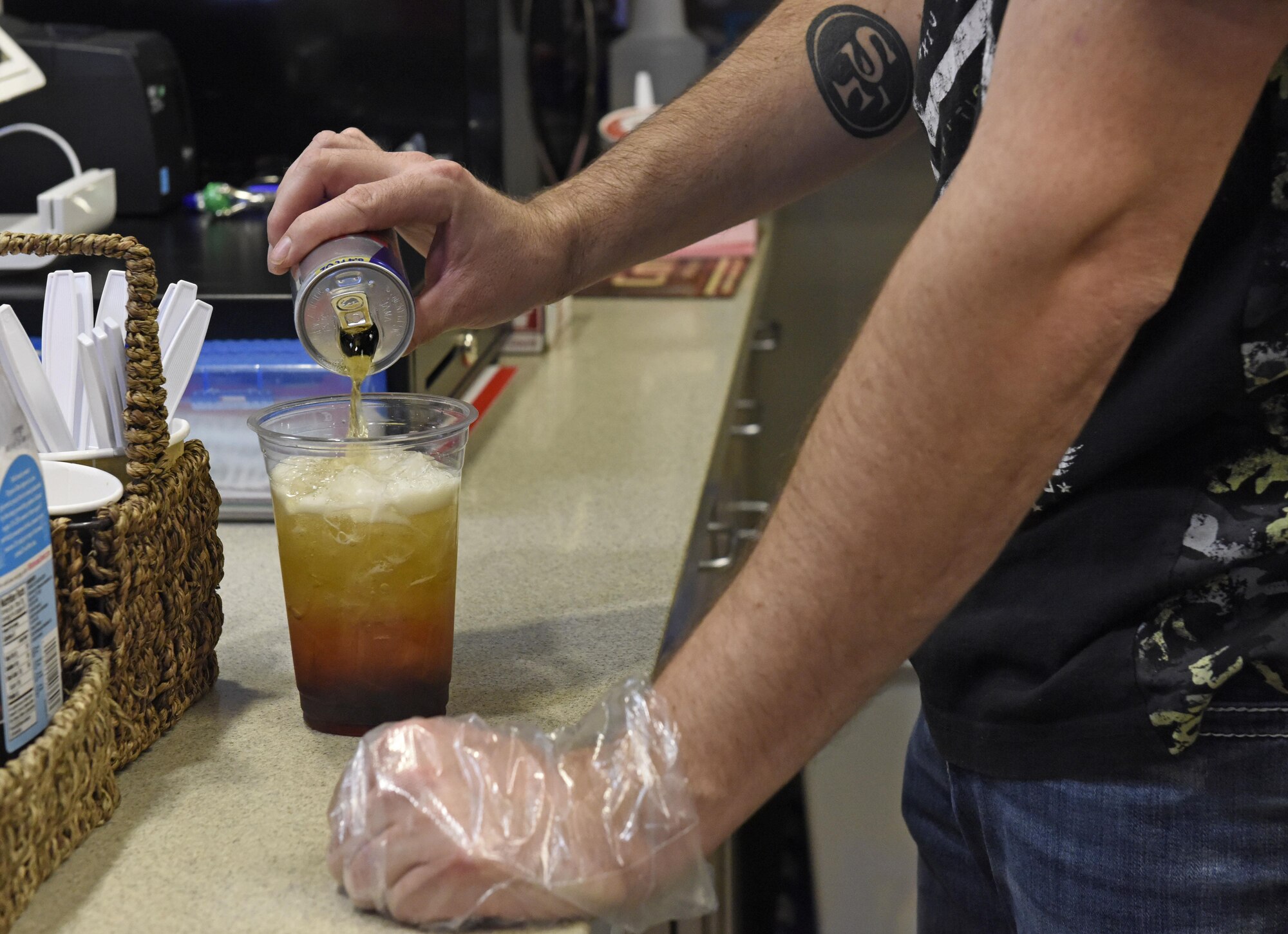 Larry Bowman, U.S. Air Force retiree and owner of the Coffee Corner, pours energy drink to a cold beverage at Fairchild Air Force Base, Wash., Sept. 26, 2017. Bawman said he has always had an entrepreneur mindset. He pursued an accounting degree using his GI Bill benefits, then invested in a coffee shop at Fairchild to fulfill his dream of being his own boss. (U.S. Air Force photo/Airman 1st Class Jesenia Landaverde)