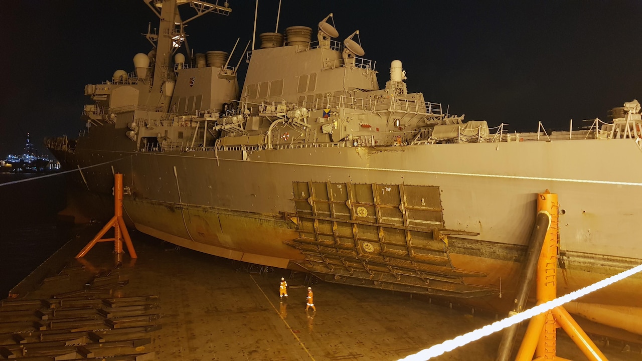 The guided missile destroyer USS John S. McCain sits on heavy lift transport MV Treasure in Changi, Singapore.