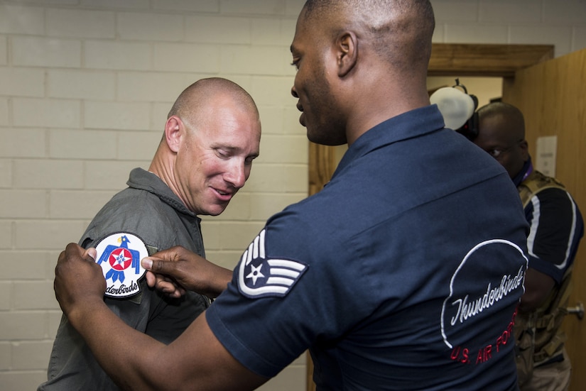 Staff Sgt. Jasper Roberts, U.S. Air Force Aerial Demonstration Squadron “Thunderbirds” aircrew flight equipment craftsman, places a Thunderbirds patch on the flight suite of Air Force Master Sgt. Benjamin Seekell, 343rd Training Squadron security forces apprentice course flight chief and Air Force Wounded Warrior, Nov. 2, 2017, at Joint Base San Antonio-Kelly Field, Texas. Seekell was selected to fly with the Thunderbirds before they headline the 2017 Joint Base San Antonio Air Show and Open House Nov. 4-5. (U.S. Air Force photo by Senior Airman Stormy Archer)