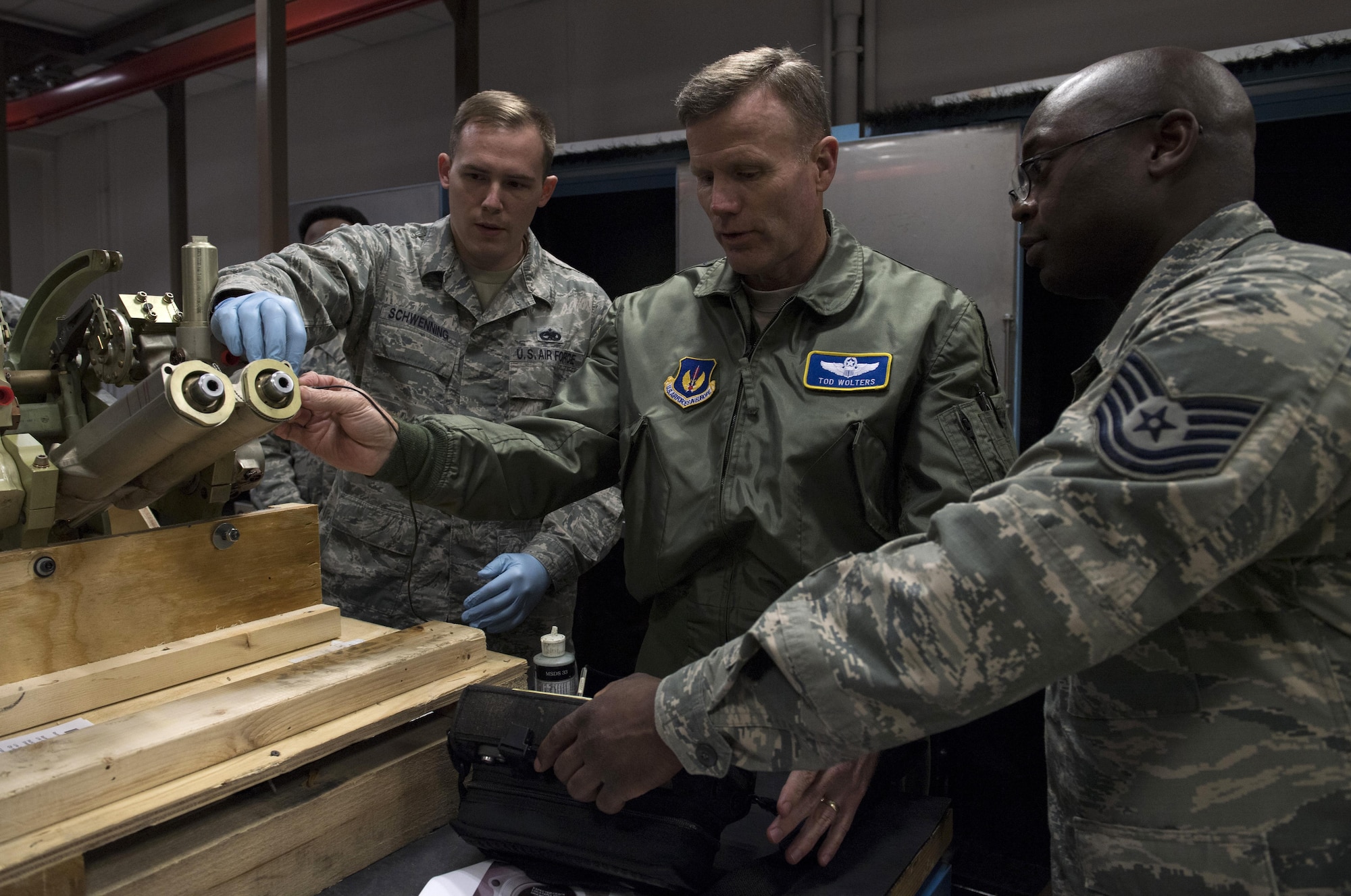 U.S. Air Force Gen. Tod D. Wolters, U.S. Air Forces in Europe and Air Forces Africa commander, tests a piece of equipment for cracks with Tech. Sgt. James Cone and Staff Sgt. Timothy J. Schwenning II, both 86th Maintenance Squadron Nondestructive Inspection technicians, during an immersion tour on Ramstein Air Base, Germany, Oct. 23, 2017. Wolters coined all four Airmen assigned to the shop for their efforts in finding the best course of action for detecting cracks in the equipment saving the Air Force money. (U.S. Air Force photo by Senior Airman Tryphena Mayhugh)