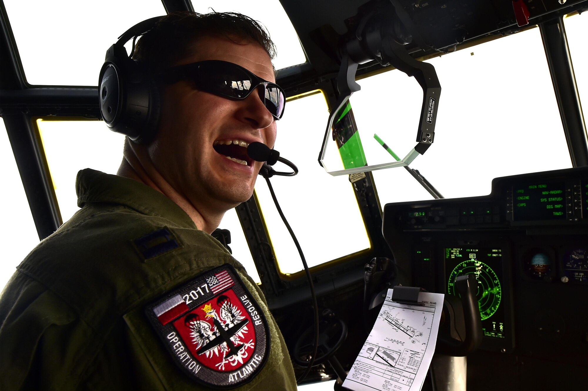 U.S. Air Force Capt. Christopher Freed, 37th Airlift Squadron pilot, laughs as he flies from Ramstein Air Base, Germany, to Powidz AB, Poland, to participate in Operation Atlantic Resolve, Oct. 13, 2017. More than 100 Airmen assigned to the 86th Airlift Wing and 934th AW participated in the NATO-led exercise. (U.S. Air Force photo by Staff Sgt. Jonathan Bass)