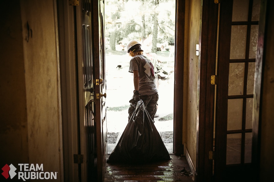 A volunteer with Team Rubicon collects debris from a resident's home in Beaumont, Texas. Many of the homes damaged by Hurricane Harvey had major reconstruction due to mold and water damage. Volunteers from all over the country, including a group of seven Airmen assigned to Whiteman Air Force Base, Mo., traveled south to the affected region to provide aid.