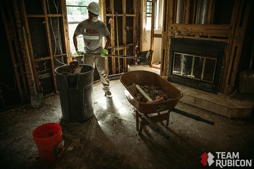 A volunteer with Team Rubicon collects debris from a resident's home in Beaumont, Texas. Many of the homes damaged by Hurricane Harvey had major reconstruction due to mold and water damage.