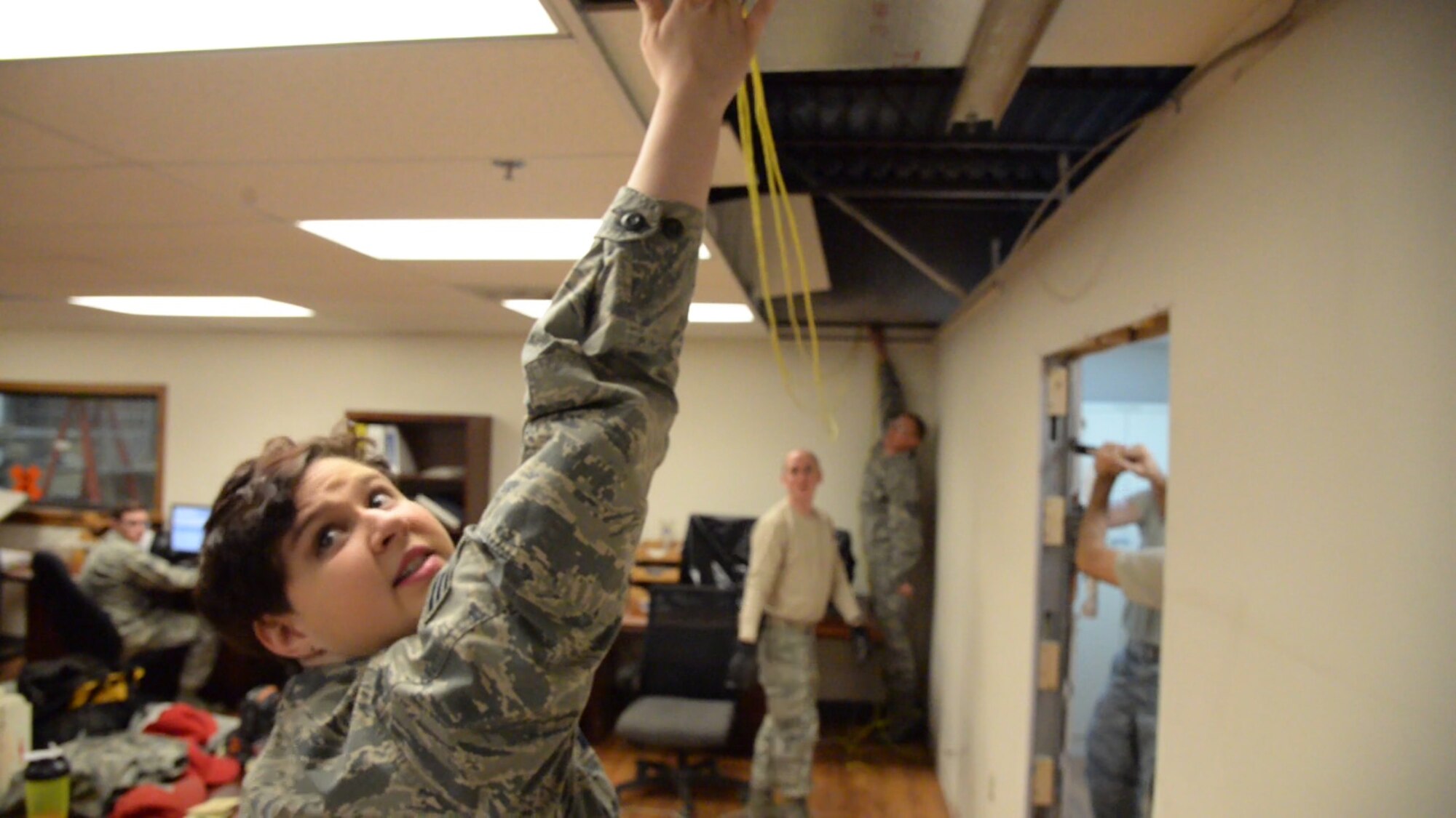 Senior Airman Margaret Merkling, 819th RED HORSE Squadron knowledge operator, assists fellow Airmen with a communication job Oct. 31, 2017, at Malmstrom Air Force Base, Mont.