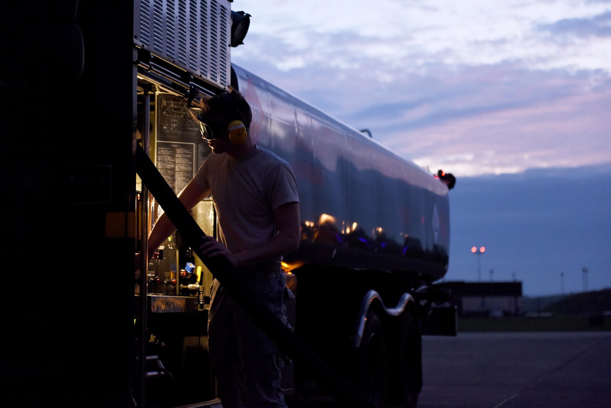 An airman first class who is a Fuels Distribution Operator from the 48th Logistics Readiness Squadron retracts a fuel hose into the fuel carrier at Royal Air Force Lakenheath, England, Oct. 26. The 48th LRS fuels management flight handles the storage and delivery of gasoline, diesel, jet fuel, cryogenic liquids and other exotic materials required to project airpower. (U.S. Air Force photo/ Airman 1st Class John A. Crawford)