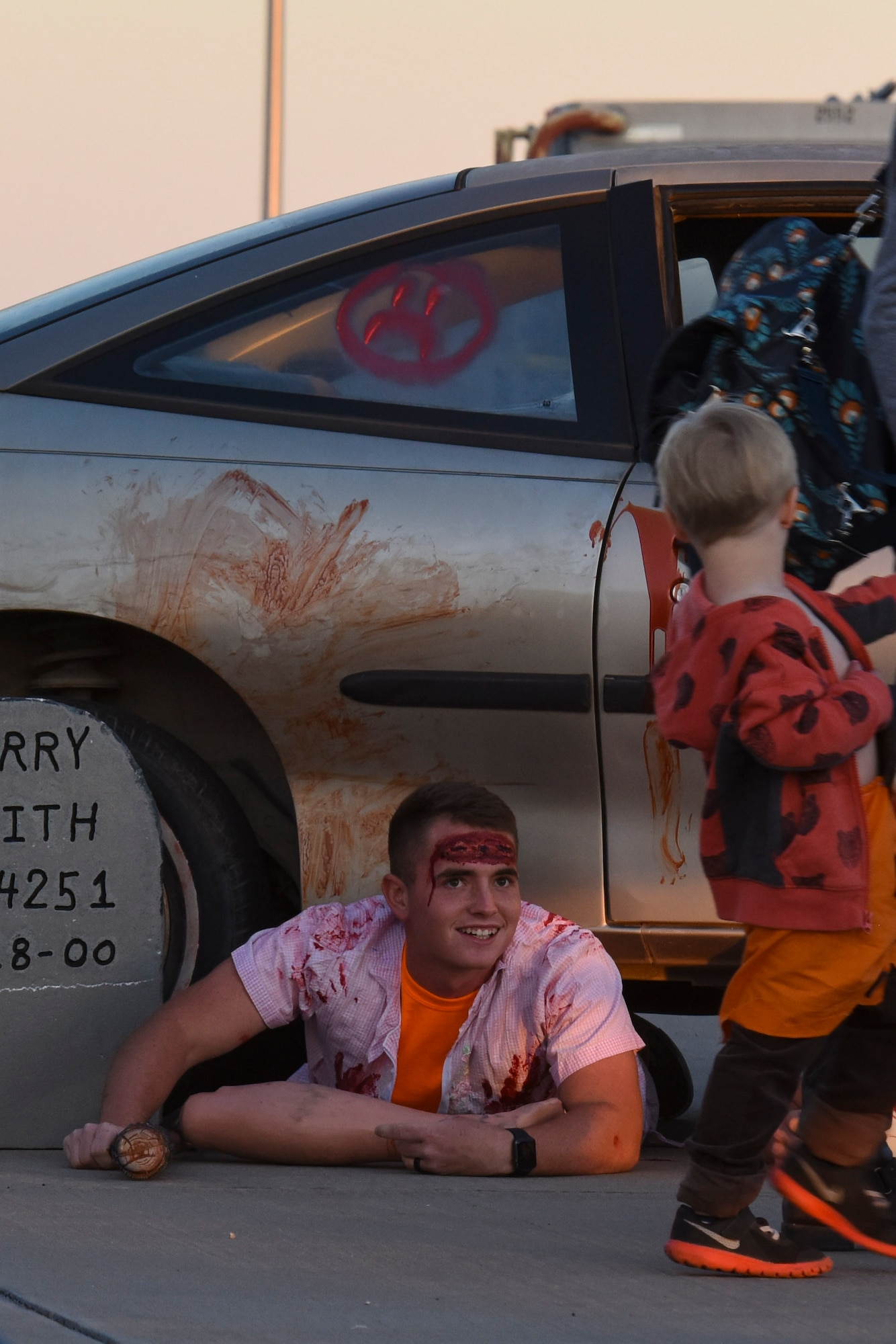 A volunteer dressed as a zombie scares a child as they leave the haunted house of Ghoulfellow at Louis F. Garland Department of Defense Fire Academy on Goodfellow Air Force Base, Texas, Oct. 28, 2017. One part of the event was the haunted house set up in the fire training tower and showcased jump scares, smoke machines and dark walk ways. (U.S. Air Force photo by Airman 1st Class Zachary Chapman/Released)