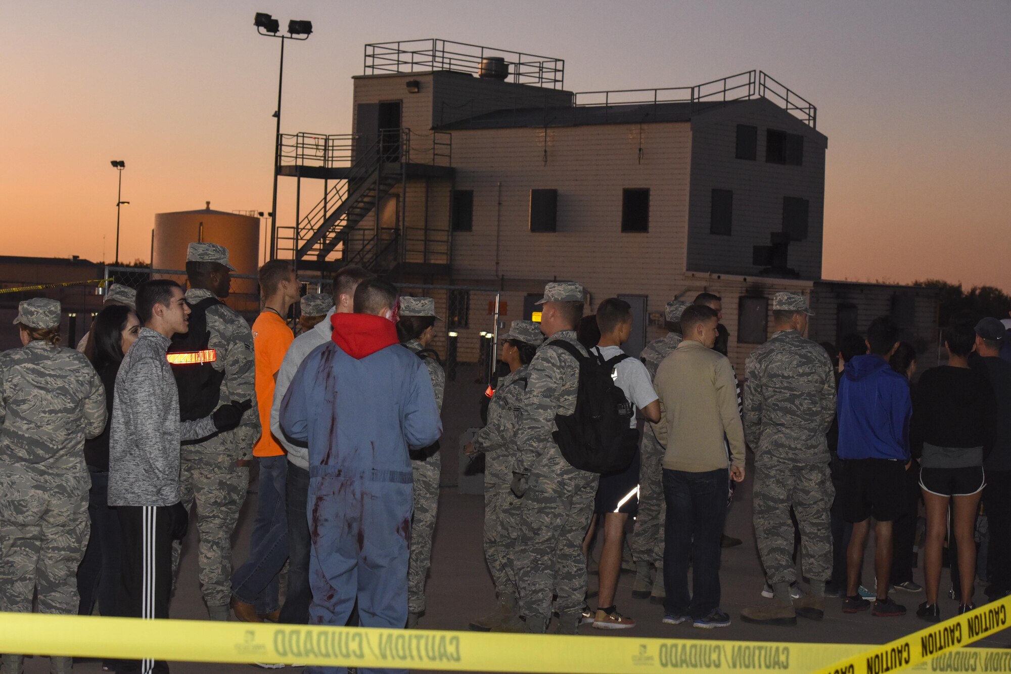 Guests wait in line to enter the haunted house at Louis F. Garland Department of Defense Fire Academy on Goodfellow Air Force Base, Texas, Oct. 28, 2017. The haunted house was just one activity of Ghoulfellow and was located at the fire training tower. (U.S. Air Force photo by Airman 1st Class Zachary Chapman/Released)