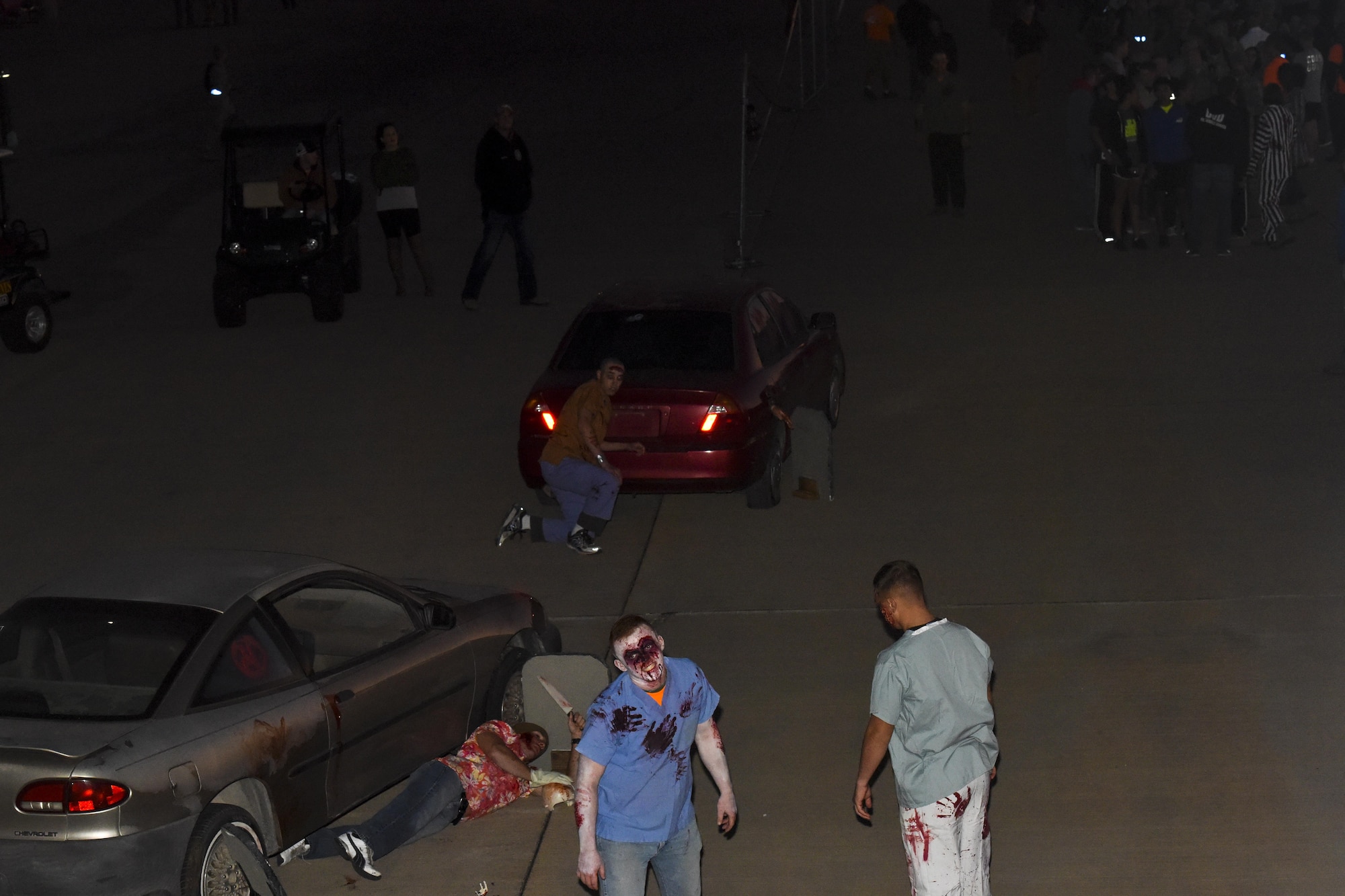 Volunteers dressed as zombies roam outside the entrance of the fire training tower as part of the haunted house at Louis F. Garland Department of Defense Fire Academy on Goodfellow Air Force Base, Texas, Oct. 28, 2017. Ghoulfellow was a Halloween event that took place throughout Goodfellow and activity that was the haunted house. (U.S. Air Force photo by Airman 1st Class Zachary Chapman/Released)