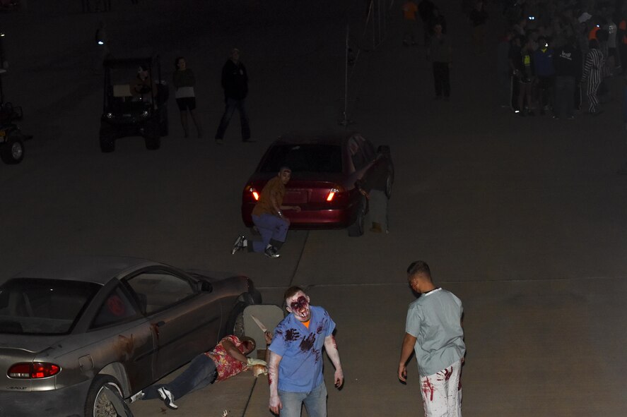Volunteers dressed as zombies roam outside the entrance of the fire training tower as part of the haunted house at Louis F. Garland Department of Defense Fire Academy on Goodfellow Air Force Base, Texas, Oct. 28, 2017. Ghoulfellow was a Halloween event that took place throughout Goodfellow and activity that was the haunted house. (U.S. Air Force photo by Airman 1st Class Zachary Chapman/Released)