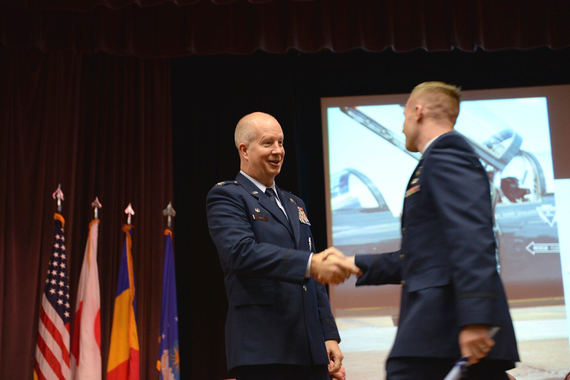 Col. Joel Carey, 12th Flying Training Wing Commander, shakes the hand of 2nd Lt. Emerson Cameron, Specialized Undergraduate Pilot Training Class 18-01 pilot, Oct. 27, 2017, on Columbus Air Force Base, Mississippi. Carey spoke in front of the class to commemorate the graduates and give them words of encouragement for the hard work ahead of them. (U.S. Air Force photo by Airman 1st Class Keith Holcomb)