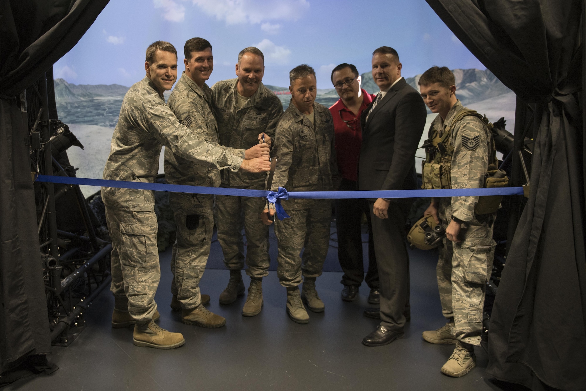 U.S. Air Force Maj. Gen. Jon T. Thomas, Headquarters United States Air Forces in Europe and Air Forces Africa Operations, Strategic Deterrence and Nuclear Integration director; U.S. Air Force Col. Michael Rider, USAFE Warrior Preparation Center commander; and WPC personnel cut a ribbon declaring the Joint Terminal Control Training and Rehearsal System’s operational status at the WPC at Einsiedlerhof Air Station, Germany, Nov. 2, 2017. The new training simulator uses multiple 4K projectors to display a 270 degree field of view for the joint terminal attack controllers. The system allows JTACs to train in a realistic and immersive setting. (U.S. Air Force photo by Senior Airman Devin Boyer)