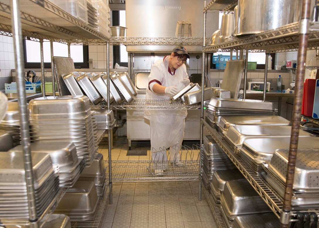Brigitte Schmitt, 786th Force Support Squadron Rheinland Inn kitchen hand, puts away dishes on Ramstein Air Base, Germany, Nov. 3, 2017. The inn is responsible for approximately 1200 dormitory residents for three meals per day. (U.S. Air Force photo by Senior Airman Elizabeth Baker)