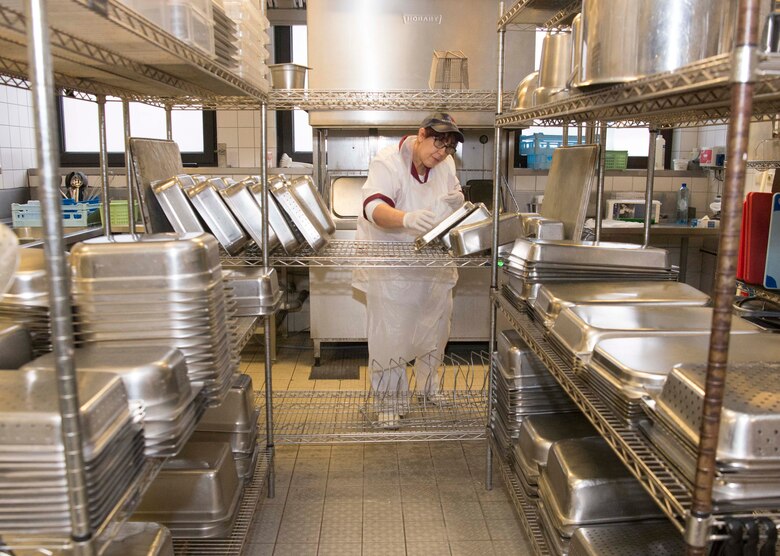 Brigitte Schmitt, 786th Force Support Squadron Rheinland Inn kitchen hand, puts away dishes on Ramstein Air Base, Germany, Nov. 3, 2017. The inn is responsible for approximately 1200 dormitory residents for three meals per day. (U.S. Air Force photo by Senior Airman Elizabeth Baker)