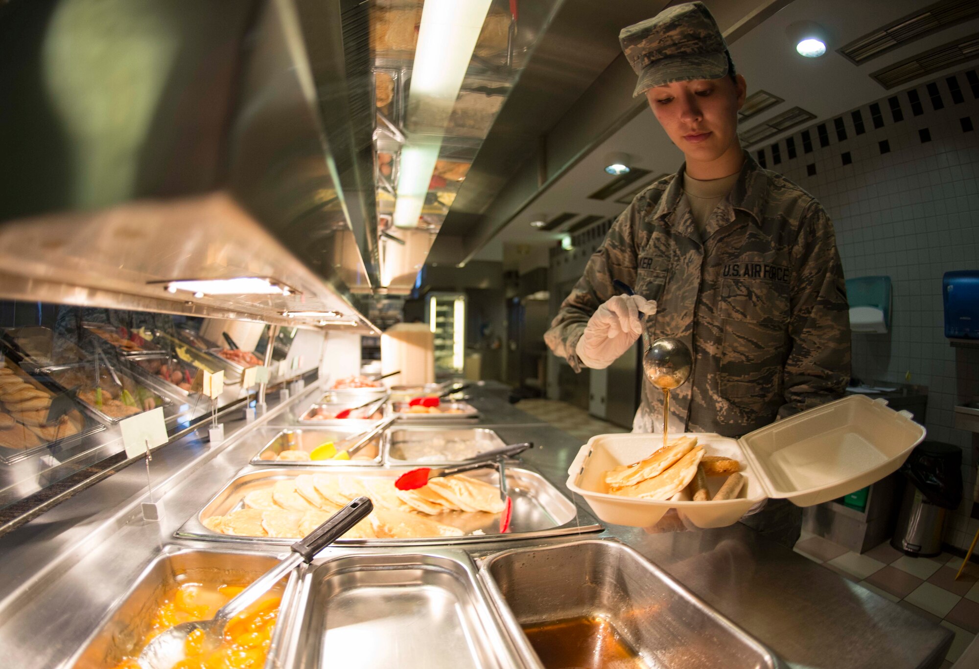 U.S. Air Force Airman Ninah Baker, 786th Force Support Squadron Rheinland Inn shift leader, fills a takeaway box on Ramstein Air Base, Germany, Nov. 3, 2017. The inn feeds an average of 250 breakfast customers per day. (U.S. Air Force photo by Senior Airman Elizabeth Baker)