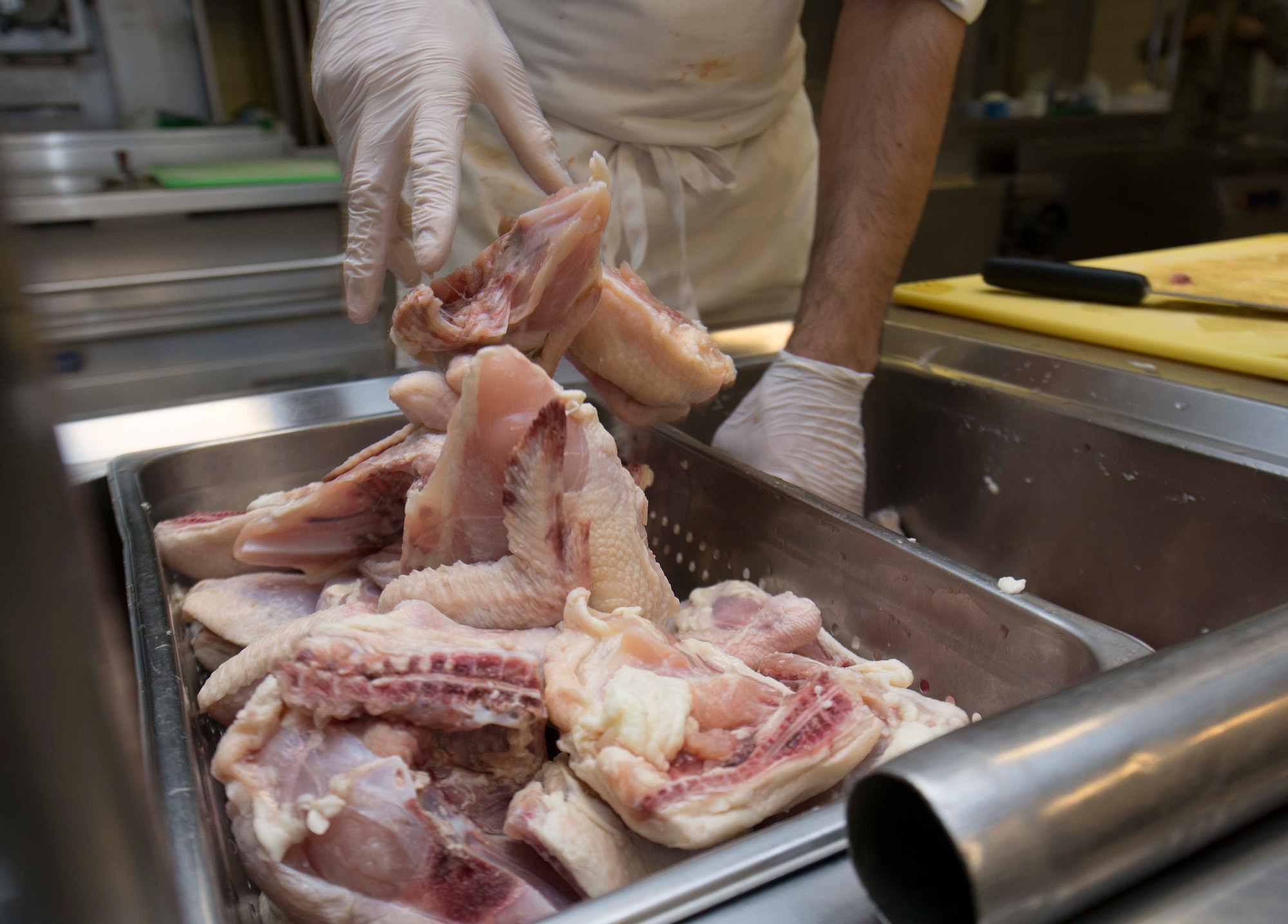 Carsten Mueller, 786th Force Support Squadron Rheinland Inn lead cook, prepares chicken for lunch on Ramstein Air Base, Germany, Nov. 3, 2017. The Rheinland Inn mission is to provide nutritious, flavorful and quality meals for dormitory residents. (U.S. Air Force photo by Senior Airman Elizabeth Baker)