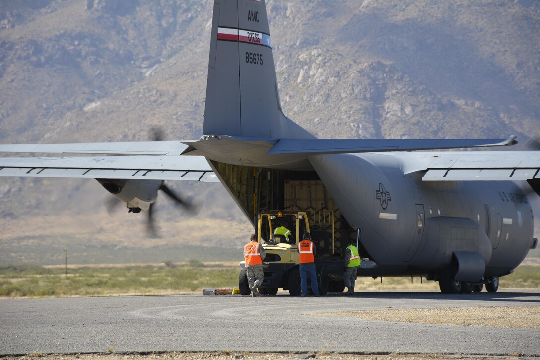 Ground crew unloads transport airplane.