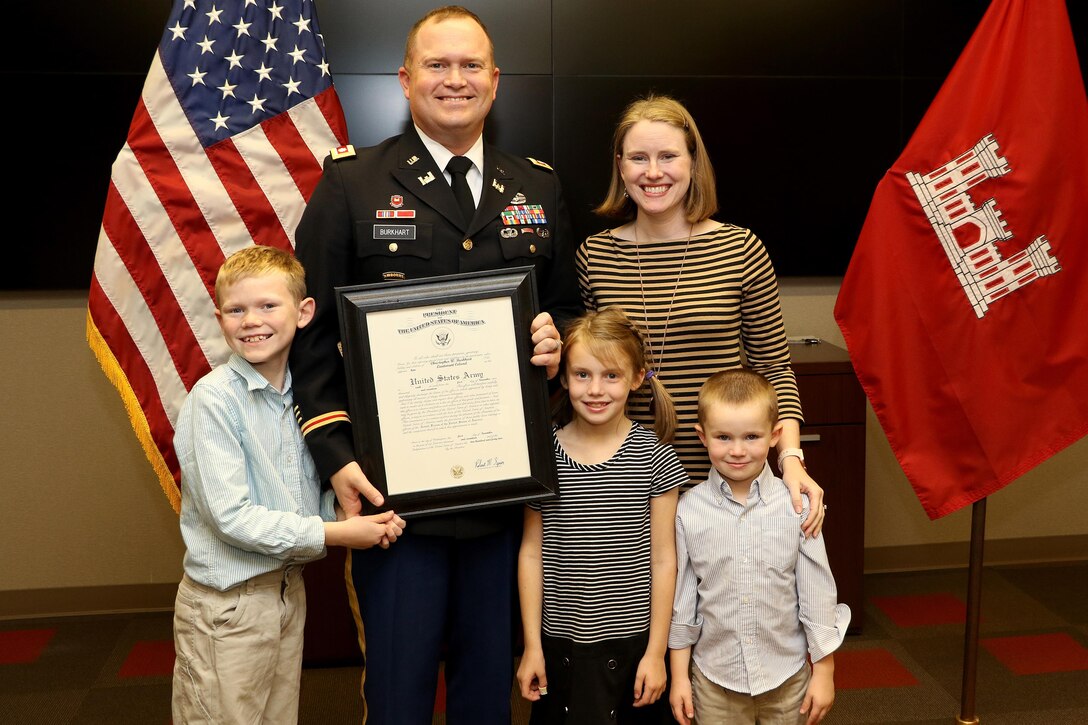 Lt. Col. Christopher Burkhart, U.S. Army Corps of Engineers Nashville District deputy commander, poses with his wife Constance and children while holding his promotion certificate during a promotion ceremony in Nashville, Tenn., Nov. 2, 2017. (USACE photo by Mark Abernathy)