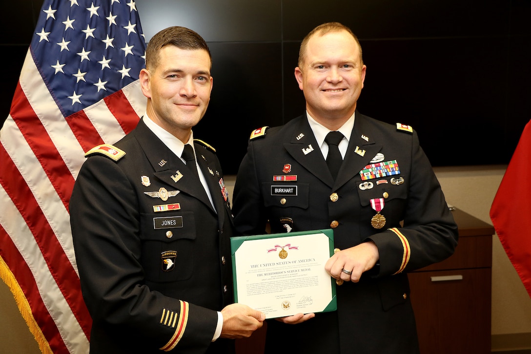 Lt. Col. Cullen Jones (Left), U.S. Army Corps of Engineers Nashville District commander, presents the U.S. Army Meritorious Service Medal to Lt. Col. Christopher Burkhart, deputy commander, for distinguished service during a farewell ceremony at the district headquarters in Nashville, Tenn., Nov. 2, 2017. (USACE photo by Mark Abernathy)