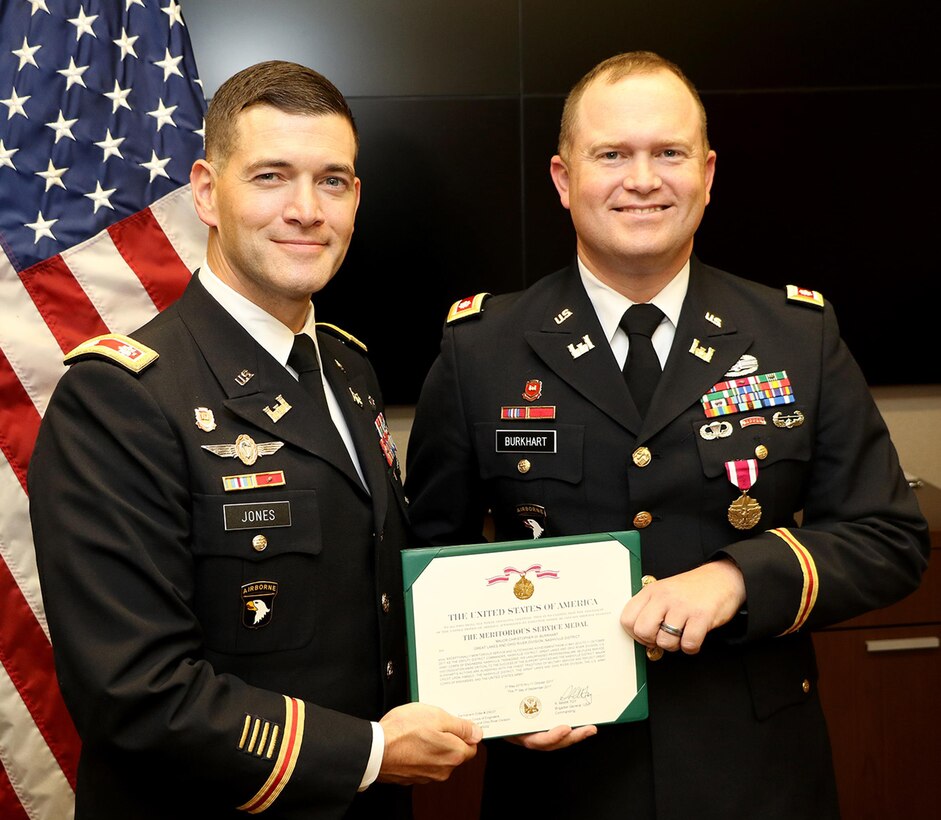 Lt. Col. Cullen Jones (Left), U.S. Army Corps of Engineers Nashville District commander, presents the U.S. Army Meritorious Service Medal to Lt. Col. Christopher Burkhart, deputy commander, for distinguished service during a farewell ceremony at the district headquarters in Nashville, Tenn., Nov. 2, 2017. (USACE Photo by Mark Abernathy)