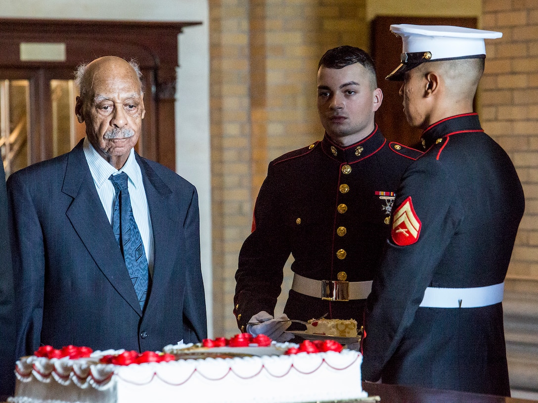 The youngest Marine in attendance, Lance Cpl. Jesus Fajardo-Garcia, Marine Barracks Washington D.C., receives a piece of the traditional birthday cake from the oldest Marine present, former PFC. Morris Craig, original Montford Point Marine, during the National Defense University’s Marine Corps Birthday Ball at Fort McNair, Washington D.C., Nov. 2, 2017. It is customary that two pieces of cake are cut during the ceremony. One is for the guest of honor and the other is for the oldest Marine who then passes it to the youngest Marine, representing the passing of knowledge and traditions from one generation to the next.