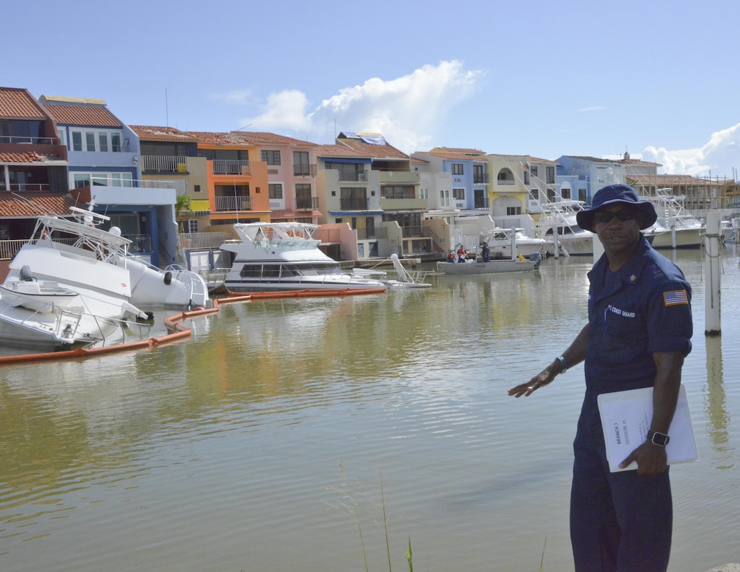 Image of Coast Guard personnel placing response stickers on hurricane damaged vessels in Puerto Rico