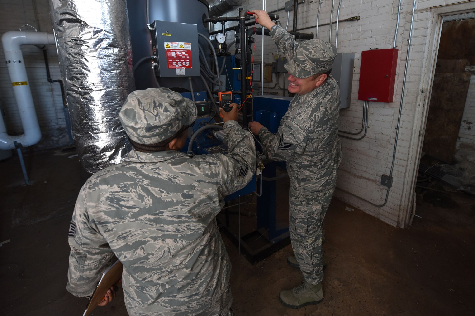 Tech. Sgt. Charles Hernandez, 90th Civil Engineering Squadron Facility Condition Assessment Team NCO in charge, takes a voltage reading while posing for a photo, on F.E. Warren Air Force base Wyo., Oct. 31, 2017. The data FCAT allocates helps units on F.E. Warren to build better and more accurate budgets, which in turn benefits big Air Force. (U.S. Air Force Photo by Airman 1st Class Braydon Williams)