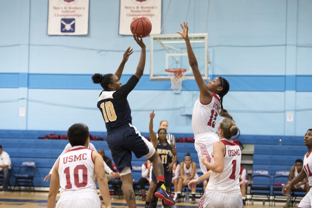 SAN ANTONIO (Nov. 02, 2017) - U.S. Navy Petty Officer 2nd Class Nyesha Adams, assigned to Naval War College, Newport, takes a shot on the basket while U.S. Marine Corps Lance Cpl. Vella Jackson, assigned to MCB Camp Pendleton, Ca., attempts to block during a basketball game. The 2017 Armed Forces Basketball Championship is held at Joint Base San Antonio, Lackland Air Force Base from 1-7 November. The best two teams during the double round robin will face each other for the 2017 Armed Forces crown. (U.S. Navy photo by Mass Communication Specialist 2nd Class Christopher Frost/Released)