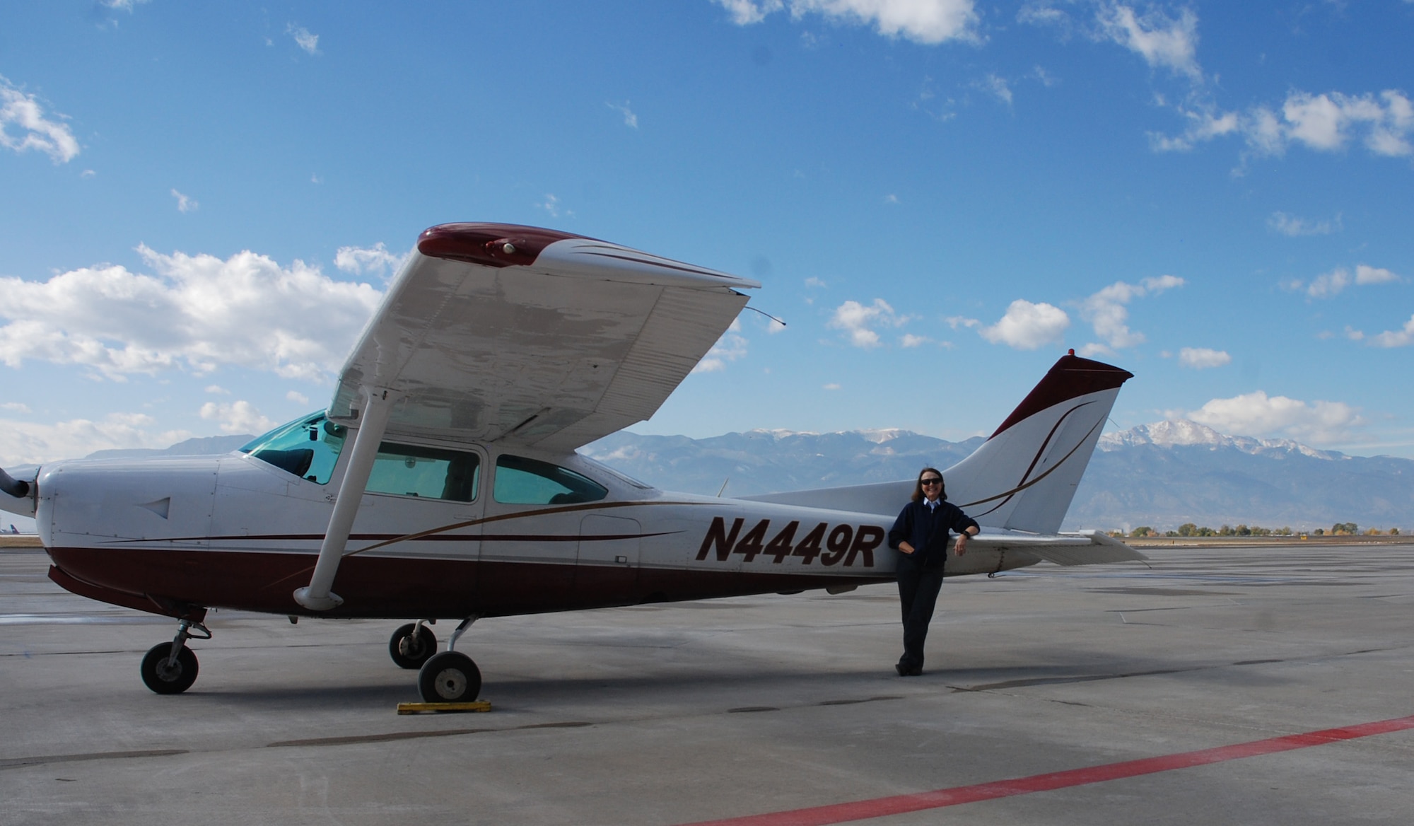 Zoan Harclerode, flight instructor at the Rocky Mountain Flight Training Center on Peterson Air Force Base, Colorado, stands by one of the aircraft she uses to train her students Oct. 31, 2017. Harclerode was named the winner of the Aircraft Owners and Pilots Association National, and Western Region, flight instructor of the year based upon the 2017 Flight Training Experience Survey. (U.S. Air Force photo by Dave Smith)