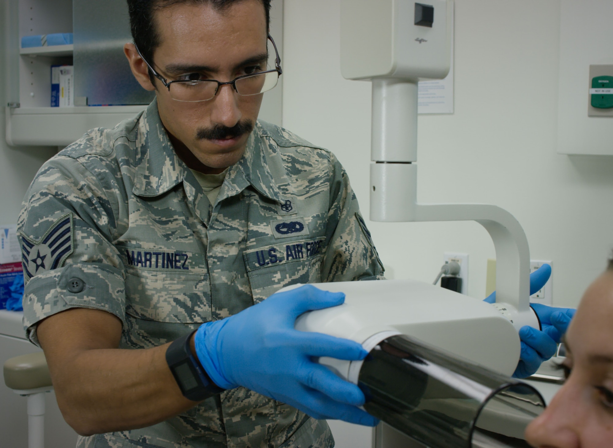 Staff Sgt. Joseph Martinez, dental assistant in the 419th Medical Squadron, conducts a dental exam