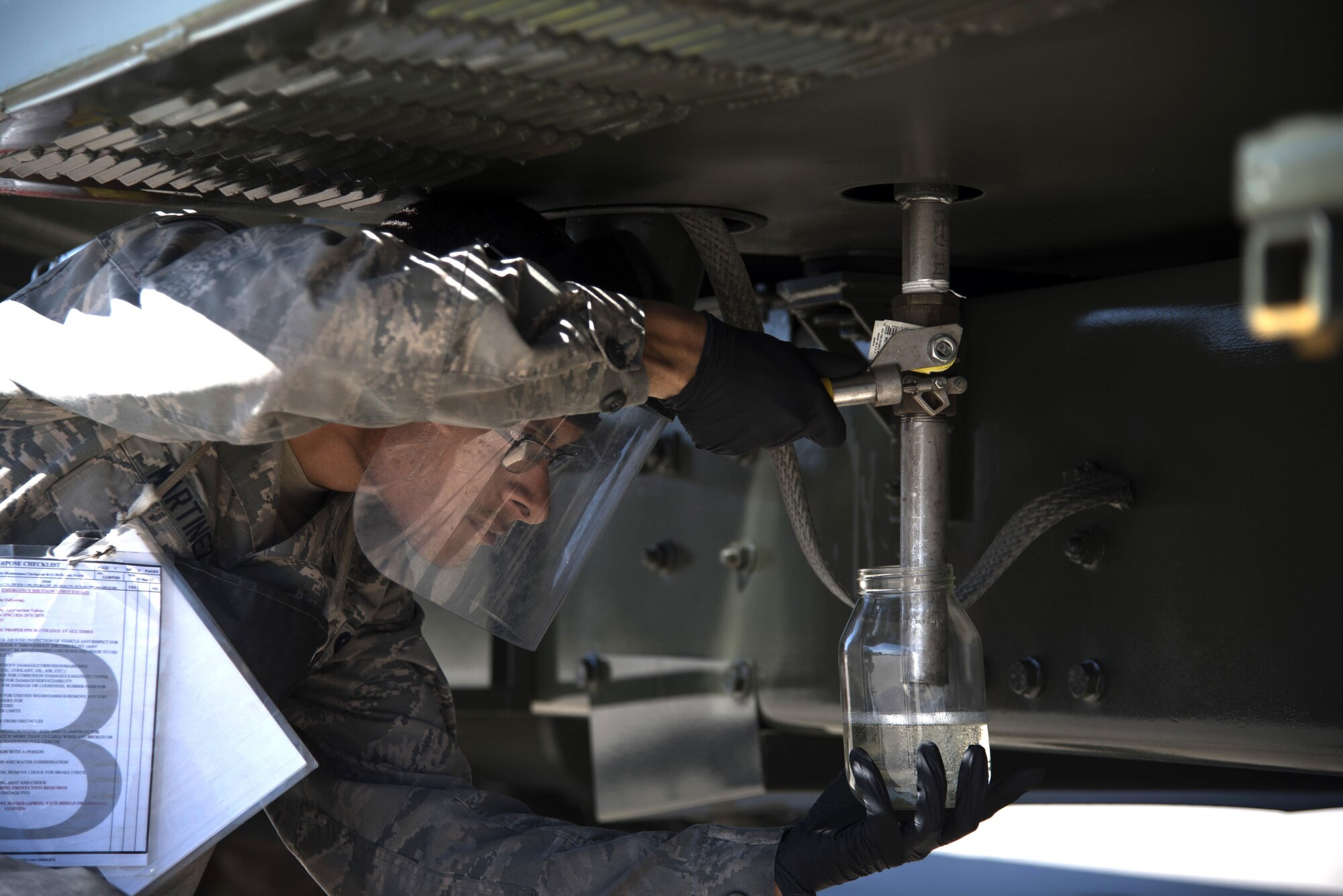 U.S. Air Force Airman 1st Class Joshua Martinez, a fuels distribution operator assigned to the 6th Logistics Readiness Squadron, performs a routine check on a fuels truck at MacDill Air Force Base Fla., Nov. 2, 2017.