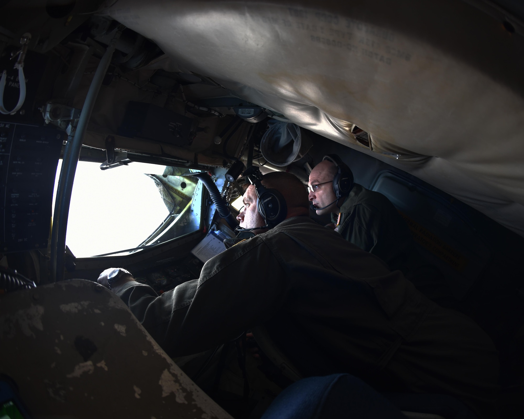 (Left to right) Staff. Sgt. Patrick Bartosavage, 924th Air Refueling Squadron boom operator, and Master. Sgt. James Yokom, 18th Air Refueling Squadron boom operator, steady the boom of a KC-135 Stratotanker, Nov. 2, 2017. During the more than four-hour flight, the KC-135 aircrew offloaded more than 4, 477 gallons of fuel and made 12 successful contacts with the jets of the U.S. Air Force Thunderbirds.