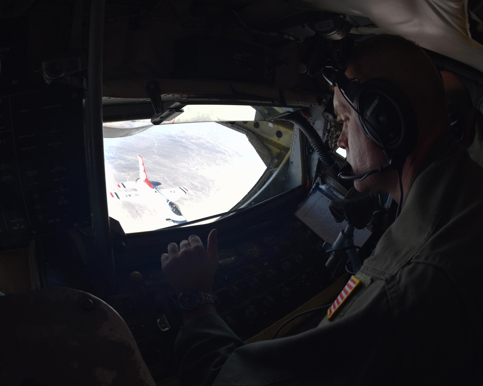 Staff. Sgt. Patrick Bartosavage, 924th Air Refueling Squadron boom operator, steadies the boom of a KC-135 Stratotanker for a member of the U.S. Air Force Thunderbirds, Nov. 2, 2017. During the more than four-hour flight, the KC-135 aircrew offloaded more than 4, 477 gallons of fuel and made 12 successful contacts with the jets of the U.S. Air Force Thunderbirds.