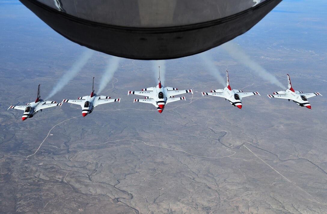 The U. S. Air Force Thunderbirds Air Demonstration Squadron, fly their F-16 Fighting Falcons in formation near the refueling boom of a KC-135 Stratotanker from McConnell Air Force Base, Kan., Nov. 2, 2017. The KC-135 provided cross-country air refueling support for the Thunderbirds. The squadron was on their way to perform at Joint Base San Antonio, Texas. The squadron performs 75 demonstrations each year.