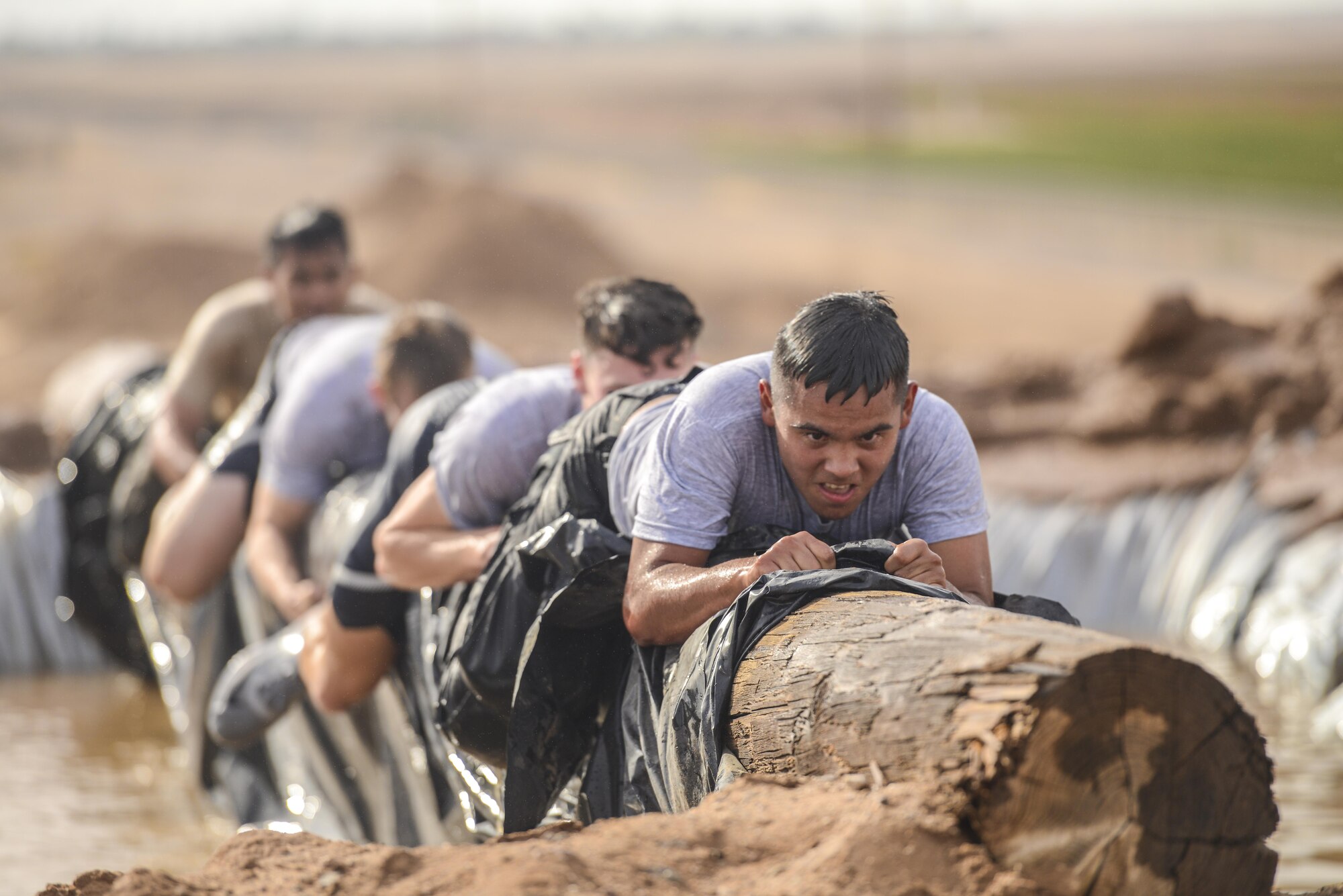 Raymond Romero, Arizona State University ROTC cadet, leads his team over an obstacle during the 4th annual Luke Mudder at Luke Air Force Base, Ariz., Nov. 3, 2017. Working in teams of four, cadets competed for the fastest time in finishing the 17 obstacle, mile and a half course. (U.S. Air Force photo/Airman 1st Class Caleb Worpel)