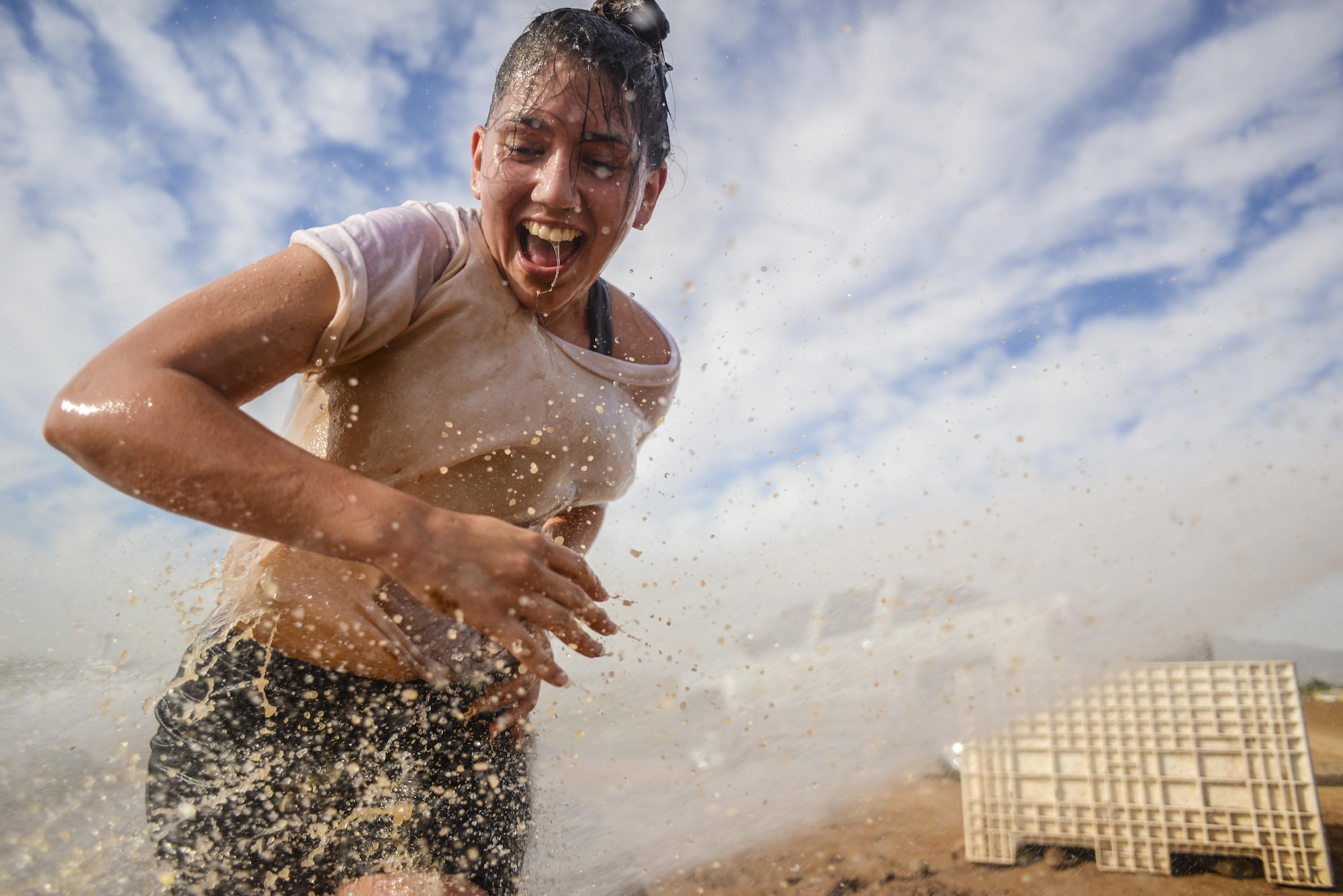 Jaimie Sirianni, Arizona State University ROTC cadet, smiles as she exits a mud run obstacle at Luke Air Force Base, Ariz., Nov. 3, 2017. The 4th annual Luke Mudder was an opportunity for cadets to close their books, get outside, connect with other detachments and start learning about Air Force lifestyle. (U.S. Air Force photo/Airman 1st Class Caleb Worpel)