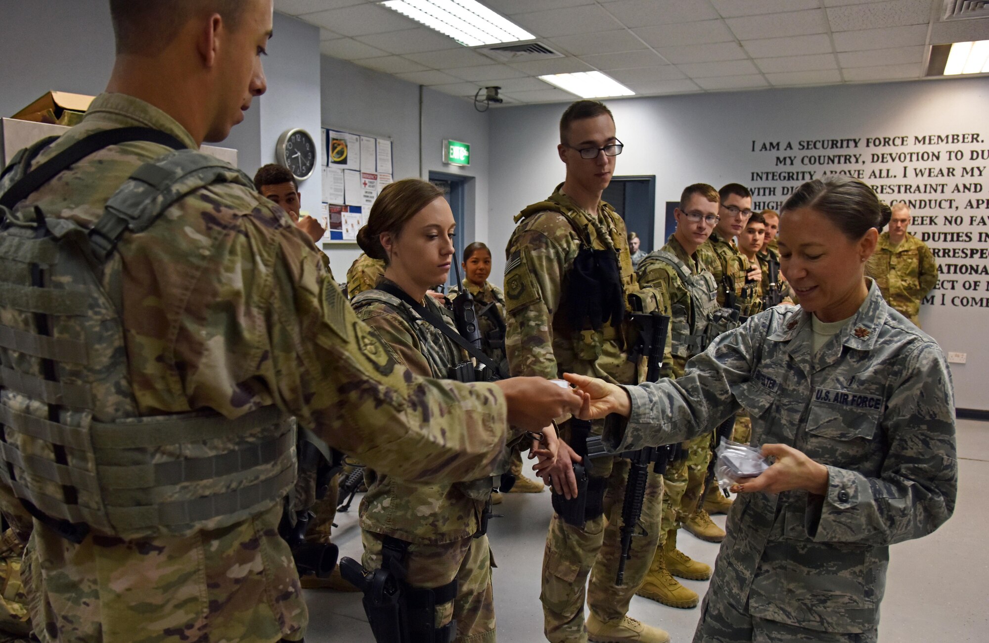U.S. Air Force Maj. Michael Glotfelter, 322nd Expeditionary Medical Group clinical psychologist, hands out Gratitude Challenge booklets at the 407th Expeditionary Security Forces Squadron on the 407th Air Expeditionary Group in Southwest Asia Nov. 3. Glotfelter wanted to do the challenge to keep morale up for deployed members. (U.S. Air Force photo by Staff Sgt. Joshua Edwards/Released)