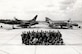 Members of the 507th Tactical Fighter Group pose for a unit photo in front of the F-105 Thunderchief and F-4 Phantom II during the unit conversion at Tinker Air Force Base, Okla. In 1980, the 507th TFG Okies were re-equipped with the McDonnell Douglas “Mig Killer” F-4D fighter aircraft. (U.S. Air Force Photo)