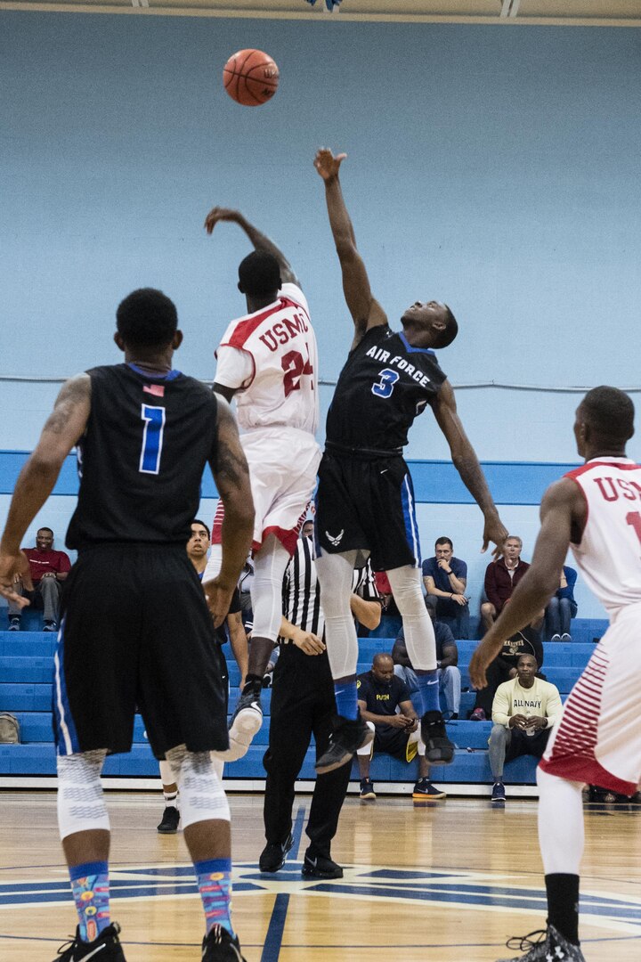 SAN ANTONIO (Nov. 03, 2017) - U.S. Air Force 1st Lt. Justin Hammonds, assigned to March Air Reserve Base, and U.S. Marine Corps Col. Demenico Jacobs, assigned to Marine Corps Air Station Cherry Point, jump for the tiup off during a basketball game. The 2017 Armed Forces Basketball Championship is held at Joint Base San Antonio, Lackland Air Force Base from 1-7 November. The best two teams during the double round robin will face each other for the 2017 Armed Forces crown. (U.S. Navy photo by Mass Communication Specialist 2nd Class Christopher Frost/Released)