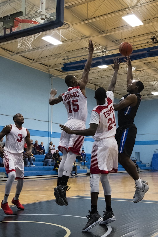 SAN ANTONIO (Nov. 03, 2017) -U.S. Marine Corps LCpl. Londel Lennon, assigned to Marine Corps Base Okinawa, and Col. Demenico Jacobs, assigned to Marine Corps Air Station Chrery Point, block a shot attempt from a member of the Air Force team during a basketball game. The 2017 Armed Forces Basketball Championship is held at Joint Base San Antonio, Lackland Air Force Base from 1-7 November. The best two teams during the double round robin will face each other for the 2017 Armed Forces crown. (U.S. Navy photo by Mass Communication Specialist 2nd Class Christopher Frost/Released)