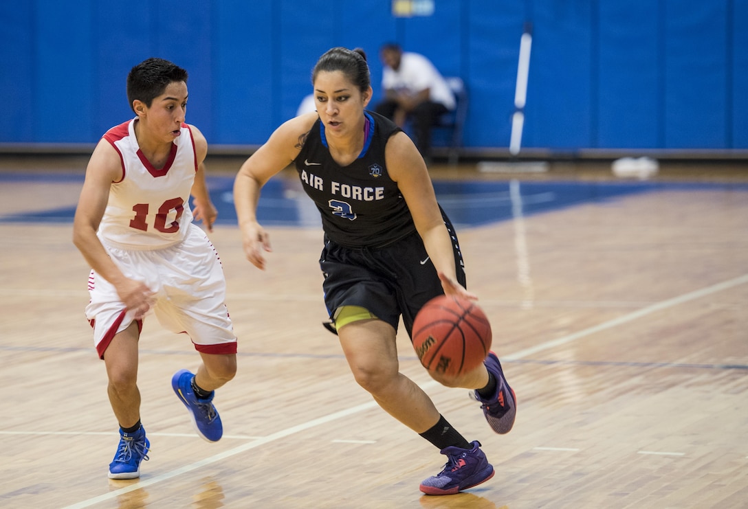 SAN ANTONIO (Nov. 03, 2017) - U.S. Airforce Ssgt. Cinnamon Kava, assigned to Travis Air Force Base, dribbles the ball during a basketball game. The 2017 Armed Forces Basketball Championship is held at Joint Base San Antonio, Lackland Air Force Base from 1-7 November. The best two teams during the double round robin will face each other for the 2017 Armed Forces crown. (U.S. Navy photo by Mass Communication Specialist 2nd Class Emiline L. M. Senn/Released)