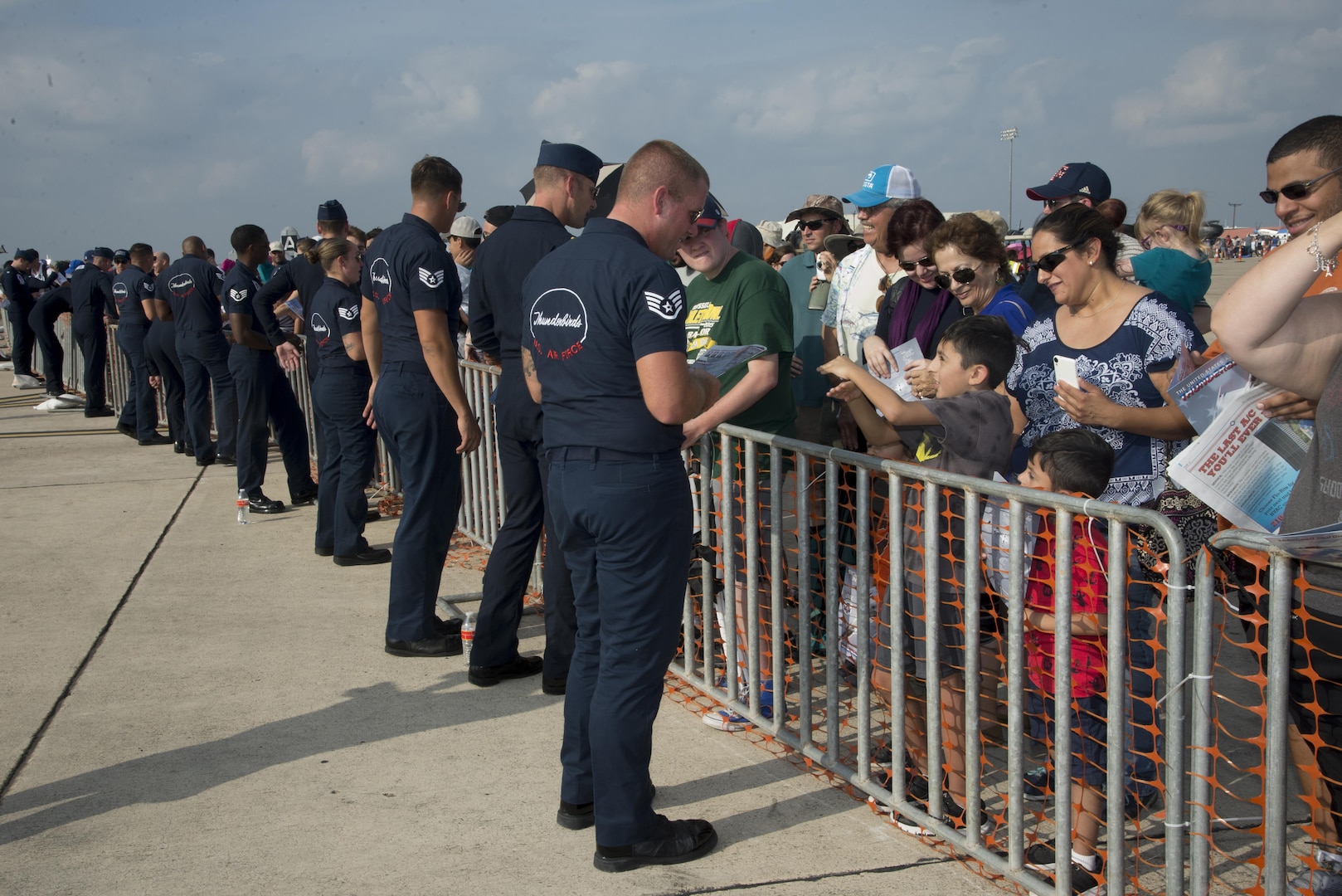 Members of the U.S. Air Force Aerial Demonstration Squadron “Thunderbirds” team sign autographs during the 2017 Joint Base San Antonio Air Show and Open House Nov. 4, at JBSA-Lackland, Kelly Field Annex.  Air shows allow the Air Force to display the capabilities of our aircraft to the American taxpayer through aerial demonstrations and static displays.  The air show gives attendees an opportunity to get up close and personal to see some of the equipment and aircraft used by the U.S. military today. (U.S. Air Force photo by Melissa Peterson/Released)