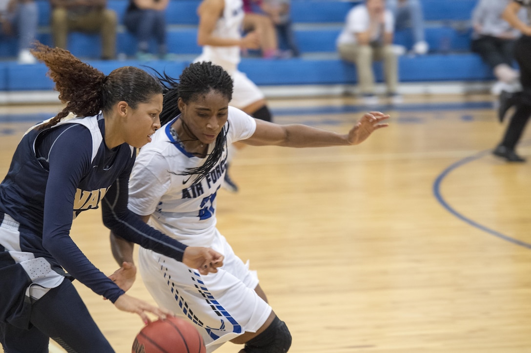 SAN ANTONIO (Nov. 04, 2017) - U.S. Navy Seaman Danika Dale, assigned to VUP-19, Point Magu, Calif., avoids a steal from U.S. Air Force Airman 1st Class Apiphany Woods, assigned to Moody AFB, during a basketball game. The 2017 Armed Forces Basketball Championship is held at Joint Base San Antonio, Lackland Air Force Base from 1-7 November. The best two teams during the double round robin will face each other for the 2017 Armed Forces crown. (U.S. Navy photo by Mass Communication Specialist 2nd Class Christopher Frost/Released)