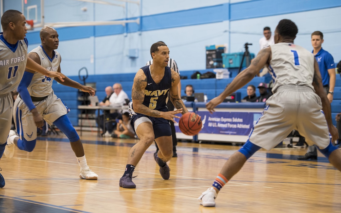 SAN ANTONIO (Nov. 04, 2017) - U.S. Navy Petty Officer 3rd Class Marquel Delancey assigned to Atlantic Area CMD Center, looks to pass the ball during a basketball game. The 2017 Armed Forces Basketball Championship is held at Joint Base San Antonio, Lackland Air Force Base from 1-7 November. The best two teams during the double round robin will face each other for the 2017 Armed Forces crown. (U.S. Navy photo by Mass Communication Specialist 2nd Class Emiline L. M. Senn/Released)