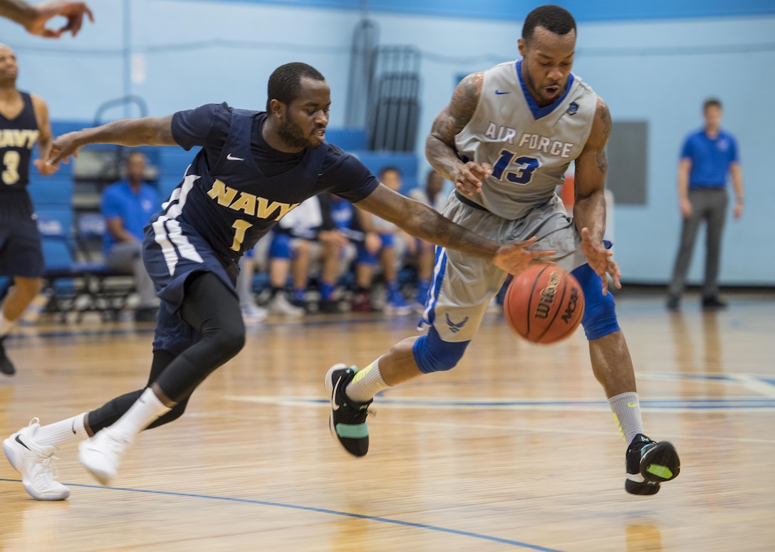 SAN ANTONIO (Nov. 04, 2017) - U.S. Navy Seaman William Sadek-Arthur, assigned to Naval Air Station Oceana, and SrA. Daveon Allen, assigned to Nellis Air Force Base, chase a loose ball during a basketball game. The 2017 Armed Forces Basketball Championship is held at Joint Base San Antonio, Lackland Air Force Base from 1-7 November. The best two teams during the double round robin will face each other for the 2017 Armed Forces crown. (U.S. Navy photo by Mass Communication Specialist 2nd Class Emiline L. M. Senn/Released)