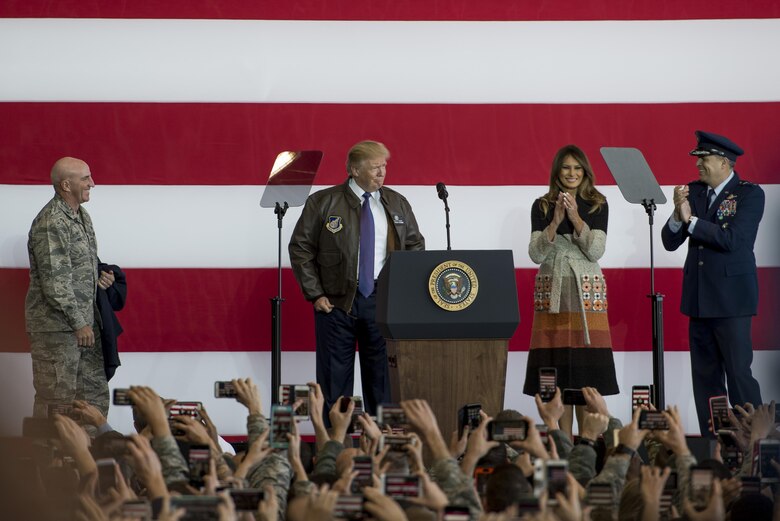 President Donald J. Trump puts on a flight jacket during a Troop Talk, Nov. 5, 2017, at Yokota Air Base, Japan.