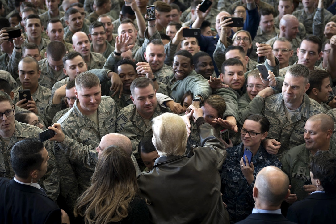 The president and first lady greet service members.