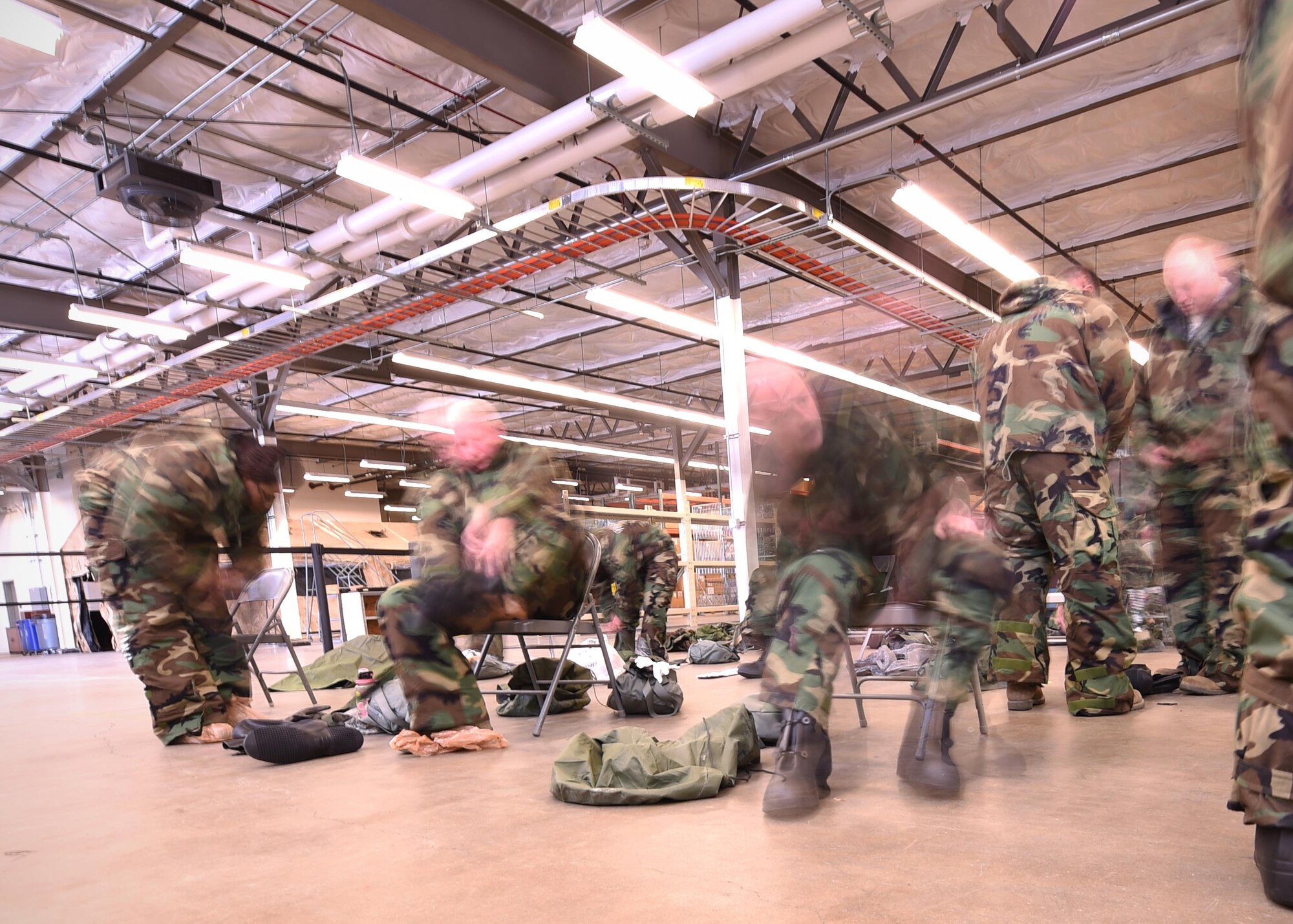 Airmen don mission oriented protective posture [MOPP] two gear at Grissom Air Reserve Base, Ind., Oct. 14, 2017.